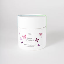 Load image into Gallery viewer, white-round-box-of-organic-rooibos-tea-and-white-lable-showing-pink-and-purple-pixelated-butterfllies